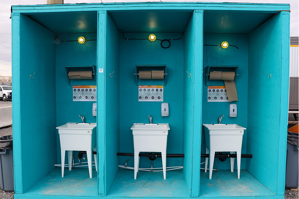 Workers must wash their hands when they arrive and leave REM construction sites